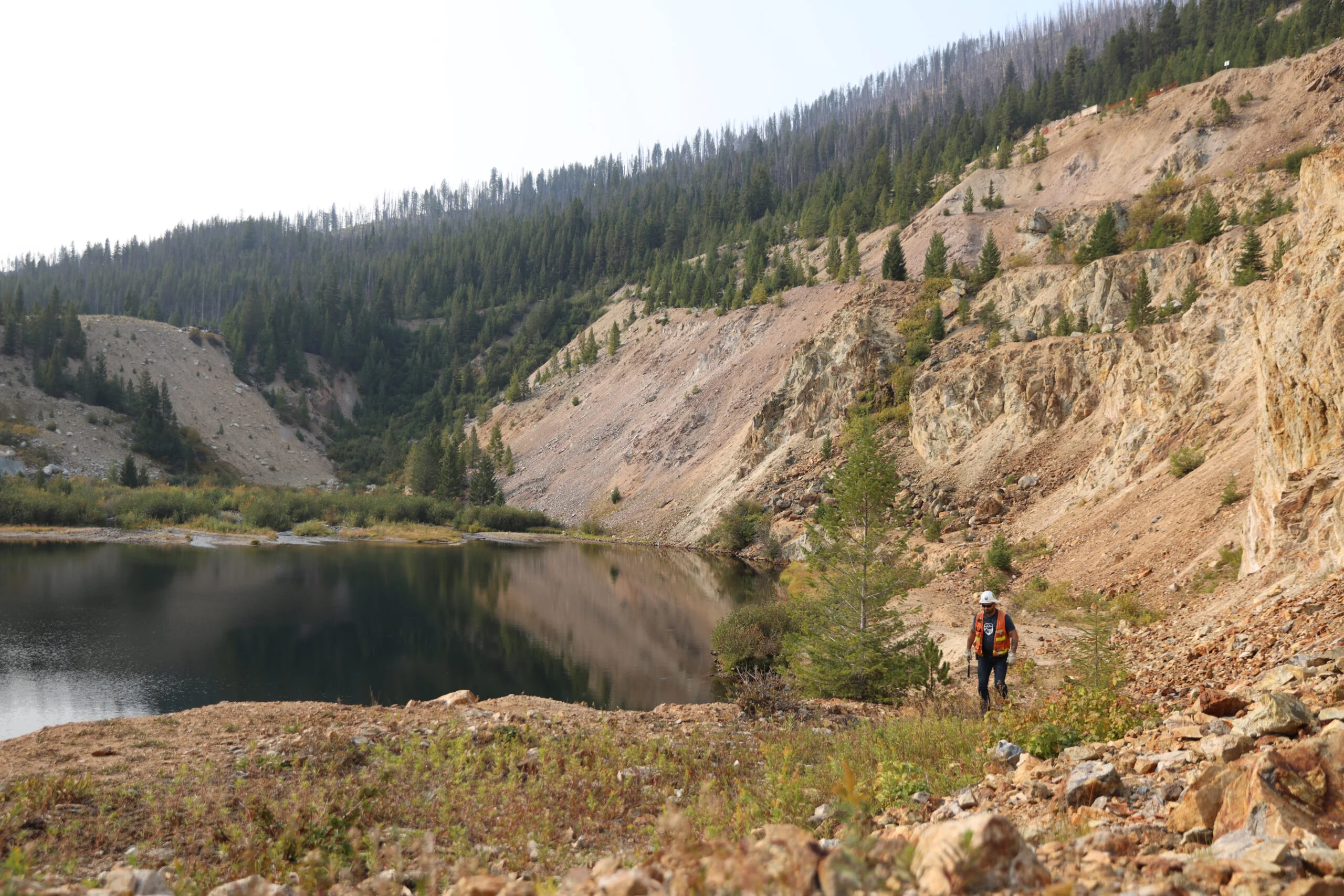 Field worker walking by pond