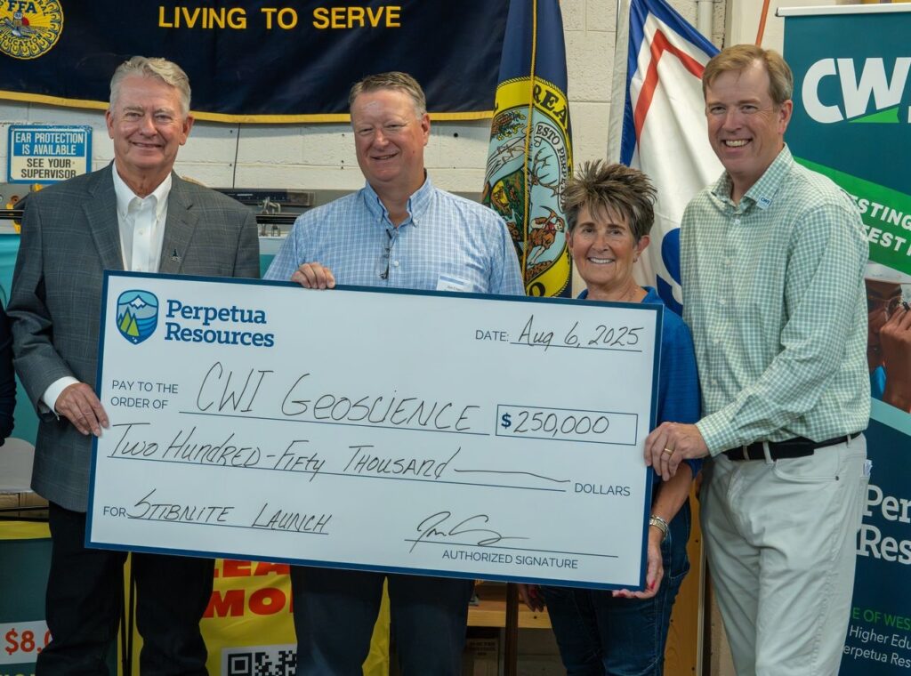 Perpetua Resources leadership holding up a check for $250,000